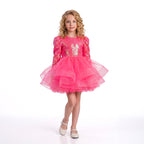 Arkası fiyonk detaylı, beyaz tüllü ve uzun kollu kız çocuk özel gün kıyafeti.