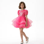 Arkası fiyonk detaylı, beyaz tüllü ve uzun kollu kız çocuk özel gün kıyafeti.